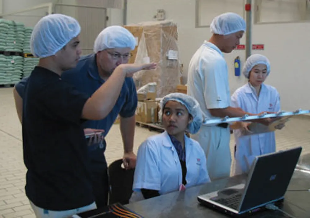 Workers in a factory with laptop